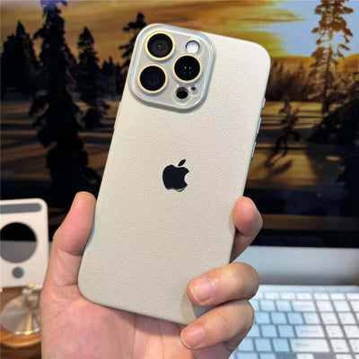 iPhone Leather Case displayed in a person's hand, showcasing premium leather design and Apple logo on the back.