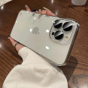 iPhone Transparent Case held in hand, showcasing the sleek design and camera features on a wooden table.