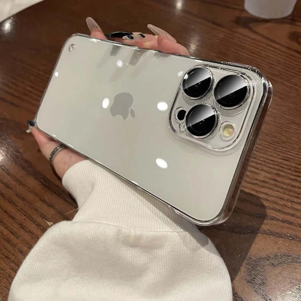 iPhone Transparent Case held in hand, showcasing the sleek design and camera features on a wooden table.