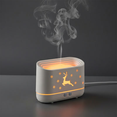 Decorative lamp with flame effect on a table, surrounded by a bottle and other items.