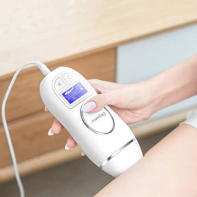 Woman using IPL laser hair removal device on her thigh for painless, long-lasting hair removal at home.